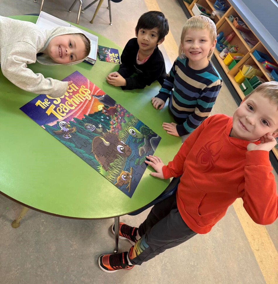 Kindergarten students completing an Indigenous jigsaw puzzle